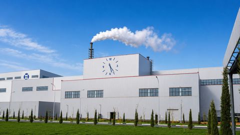 Industrial plant building with exhaust stack